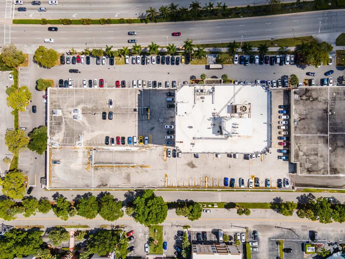 Bird's-eye rooftop aerial showing full site footprint